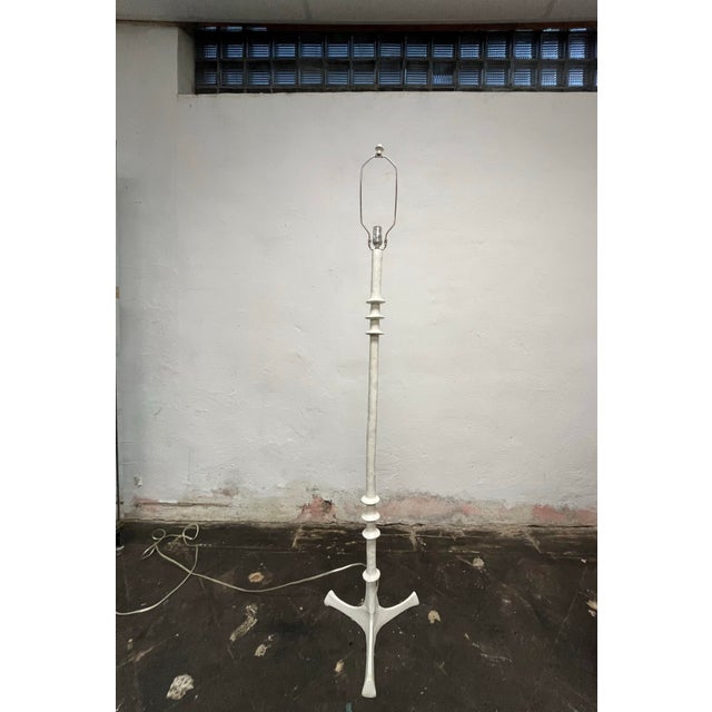 Mid-Century-style floor lamp with white painted turned design posts ending in three leg base in the manner of GIACOMETTI....