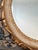 Listing is for a Italian vintage wooden oval mirror painted cream with gilt scrollwork borders accented with pops of deep...