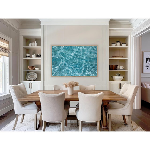 sunlight moves across coastal waters, creating a luminous pattern of turquoise, aqua, and white. shifting reflections...