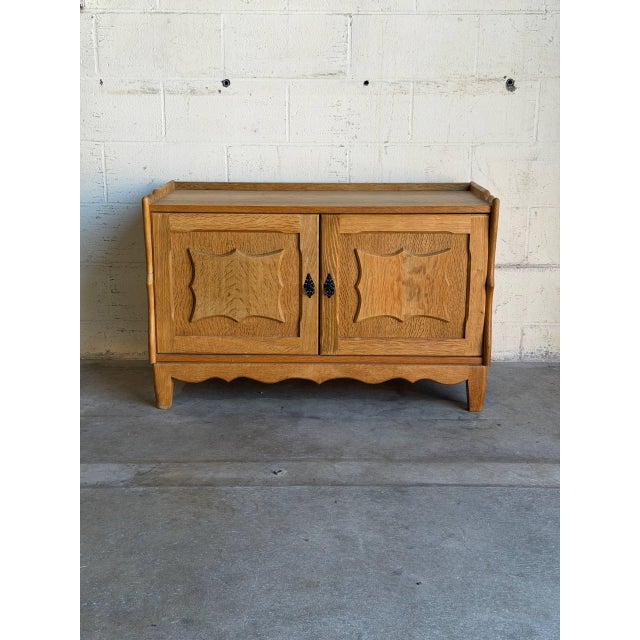 This exceptional low cabinet showcases the distinctive sculpted contours and traditional wave apron characteristic of...