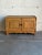 This exceptional low cabinet showcases the distinctive sculpted contours and traditional wave apron characteristic of...