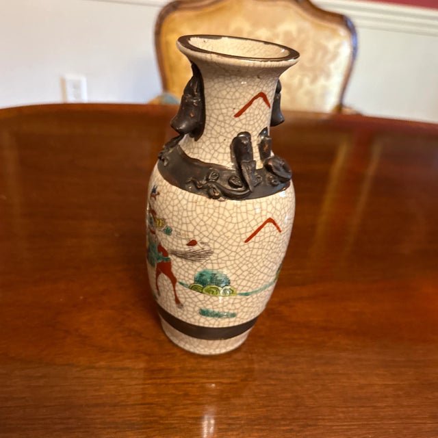 Vintage Chinese porcelain famille verte warrior crackle vase with foo dogs. Nice size for a bookcase or to add to a...