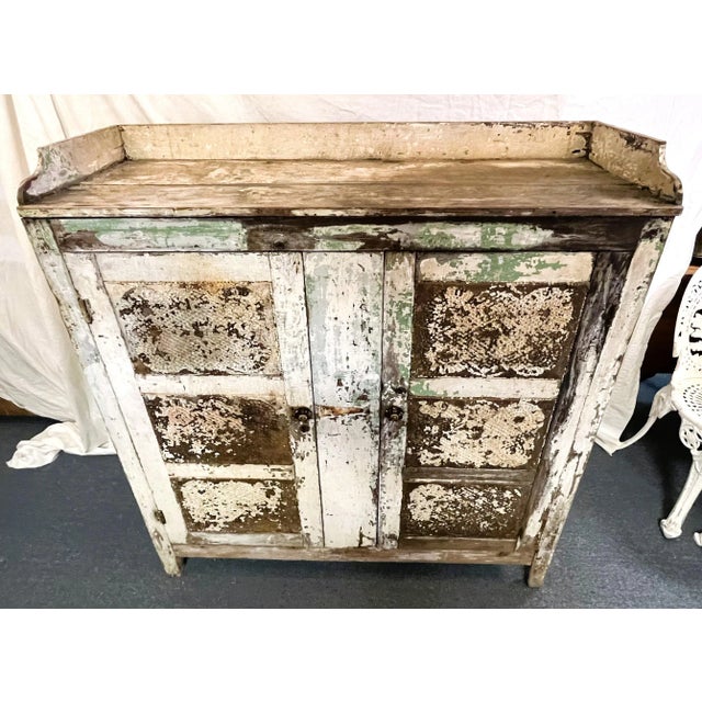 Unique antique hand made pie safe. The sturdy piece is made of solid pine with two cabinet doors. There are twelve side...