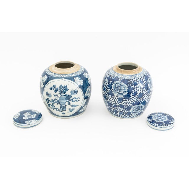 Two Chinese Blue and White Porcelain Covered Ginger Jars, each hand-painted with flowers, unmarked. Taller: 9.5" H x 8.5"...