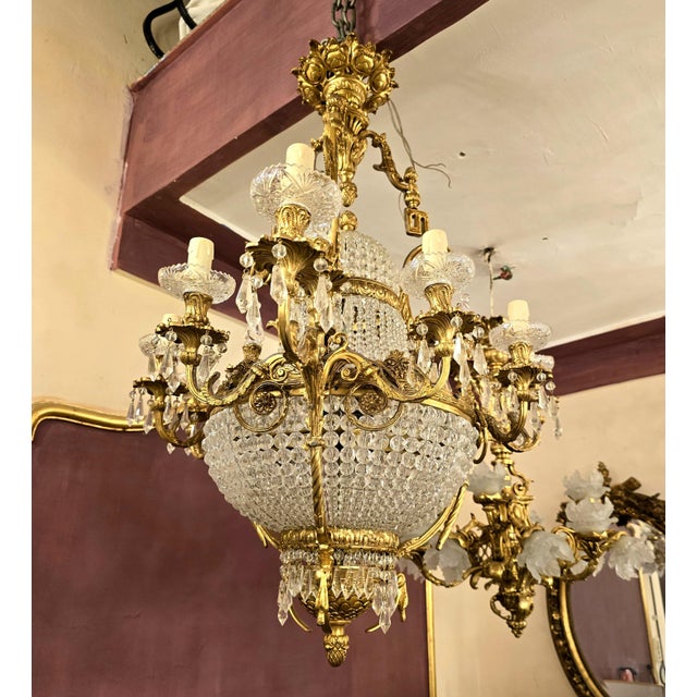 This one-of-a-kind chandelier blends grand sophistication with exquisite detail. Featuring sculpted bronze arms decorated...