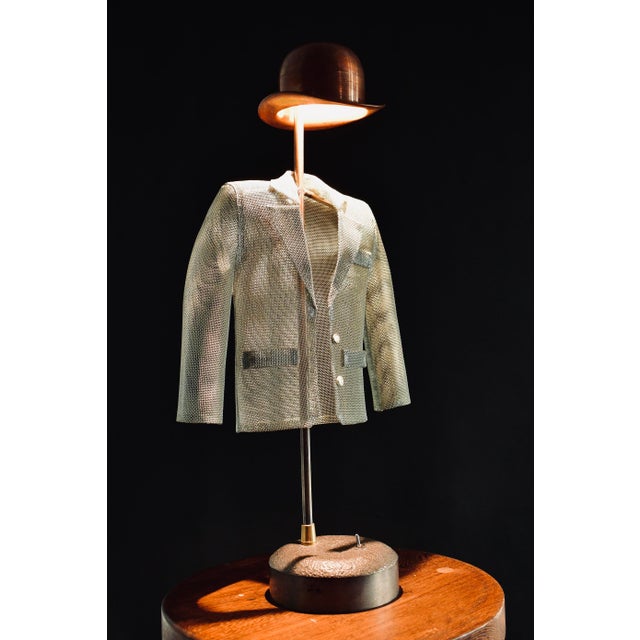 This desk lamp is equipped with a built – in LED underneath the bowler hat in copper. Inspired by René Magritte, it has a...