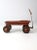 This vintage red metal pull wagon dates to the 1930s and closely resembles early Murray Mercury models. The front wheels...