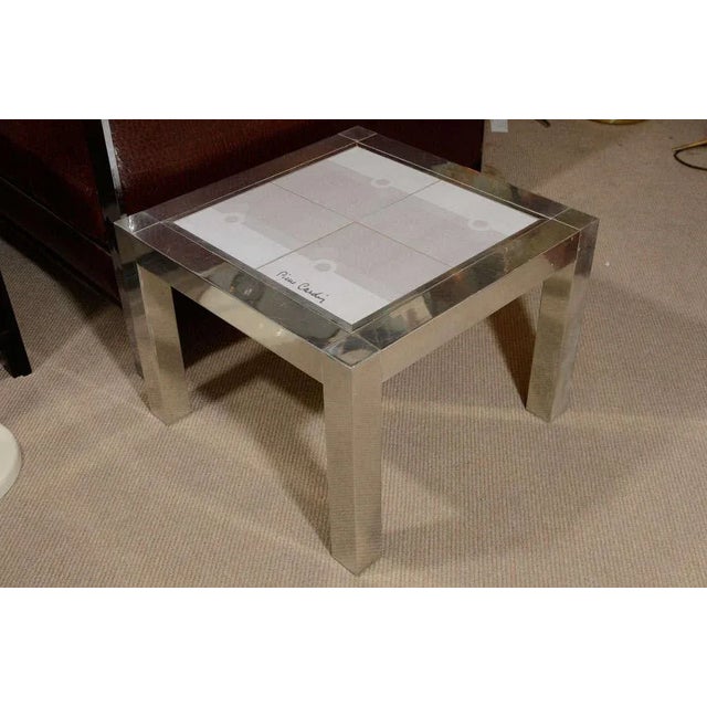 A rare Pierre Cardin end table in chrome with ceramic tile top, circa 1970. Four tiles in three shades of light grey...