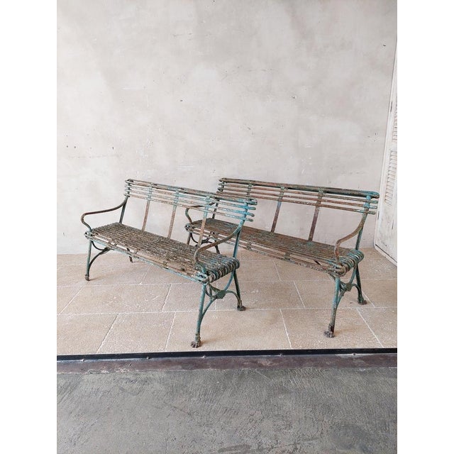 Pair of antique Arras garden benches with claw feet, and original worn green patina. from the 19th Century. Some claw feet...