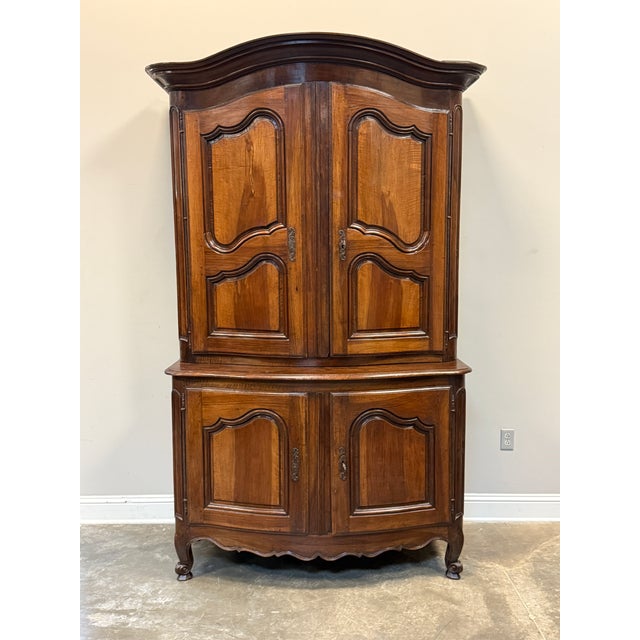 19th C. French buffet à deux corps in walnut. The design includes a "chapeau gendarme" (policeman's hat or similar to...