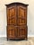 19th C. French buffet à deux corps in walnut. The design includes a "chapeau gendarme" (policeman's hat or similar to...