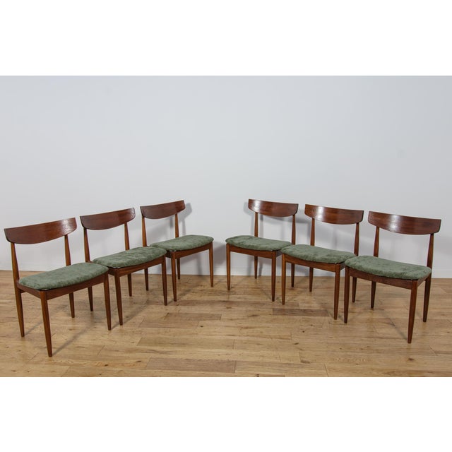 This set of six dining chairs was designed by Ib Kofod-Larsen and manufactured in the 1960s by the renowned British...