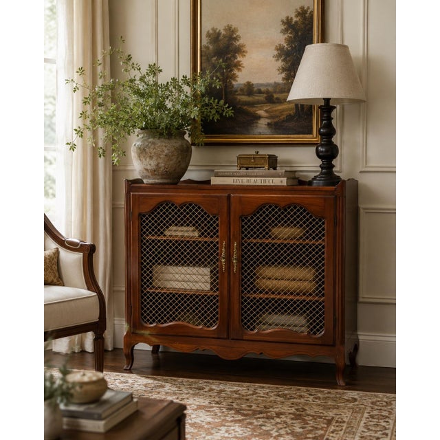 Beautiful vintage cherry wood display cabinet featuring an elegant French-inspired silhouette and warm, rich finish. The...