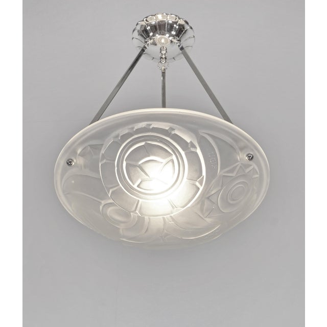 Lucien Fontaine A beautiful French art deco pendant light around 1930 in nickel plated bronze or solid brass. It holds a...