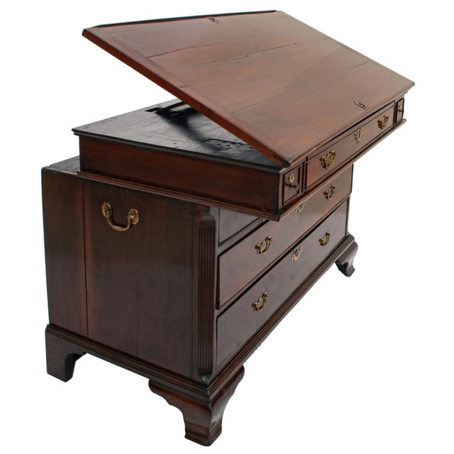 A rare George II mahogany architect's desk/chest, circa 1750. The desk/ top slides forward, thus allowing the sitter to...