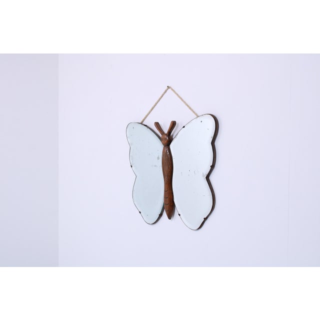 Charming and rare 1930s mirror in the elegant shape of a butterfly. A striking decorative piece that perfectly reflects...