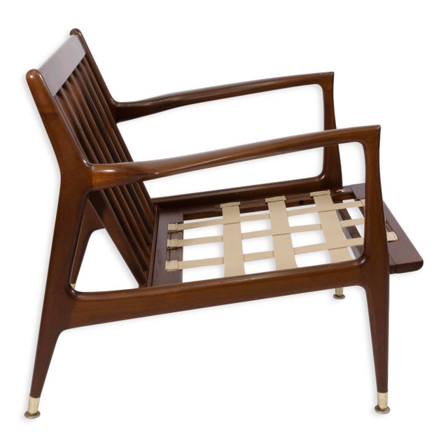 This mid-century lounge chair by Ib Kofod Larsen for Selig exemplifies classic Danish modern design. Crafted from rich...