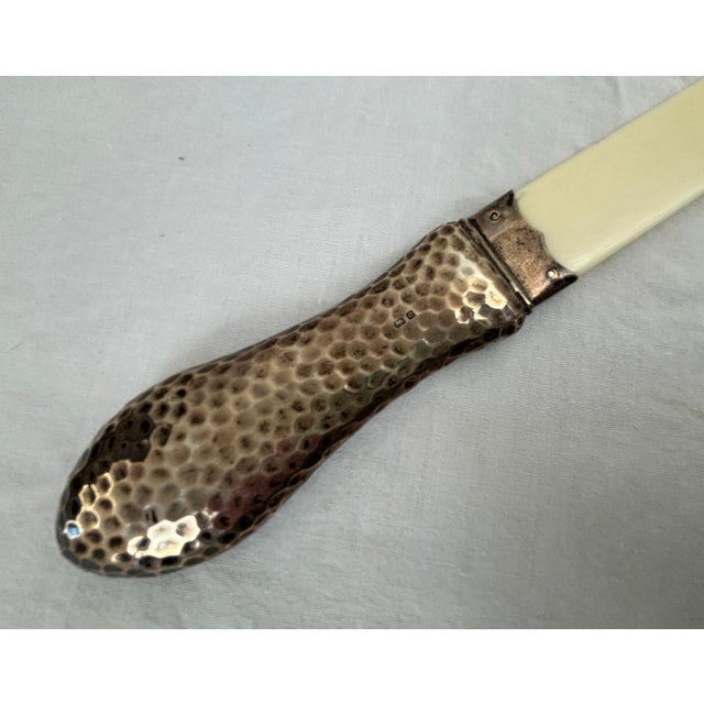 An antique, circa 1902, English sterling silver and bone page turner or paper knife trademarked “Deakin & Francis,...