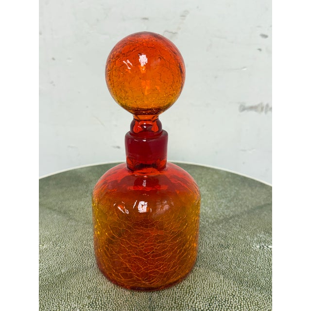Design Plus Gallery presents an Italian Hand Blown Fire Orange Glass Decanter. A striking art glass decorative bottle...