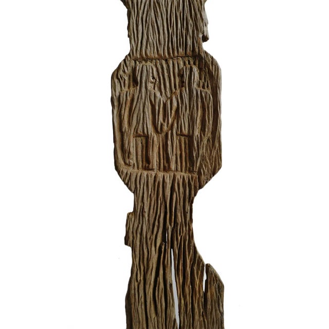 Antique Nepal carved wood ancestry post on black iron stand. Deep wood grain with signs of age. Two figures carved in...