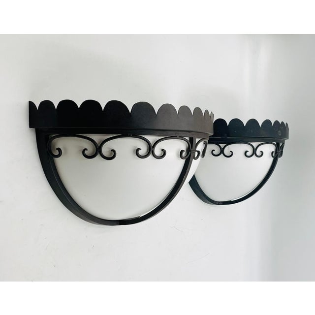 Elegant pair of custom wrought iron wall sconces with white Lucite shades, designed and handcrafted in 2004 by Steven...