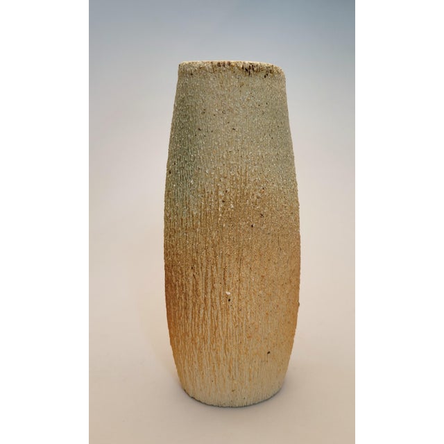 Hand signed mid century Ikebana highly textured pottery vase with unique top cut-out. I was unable to identify the...