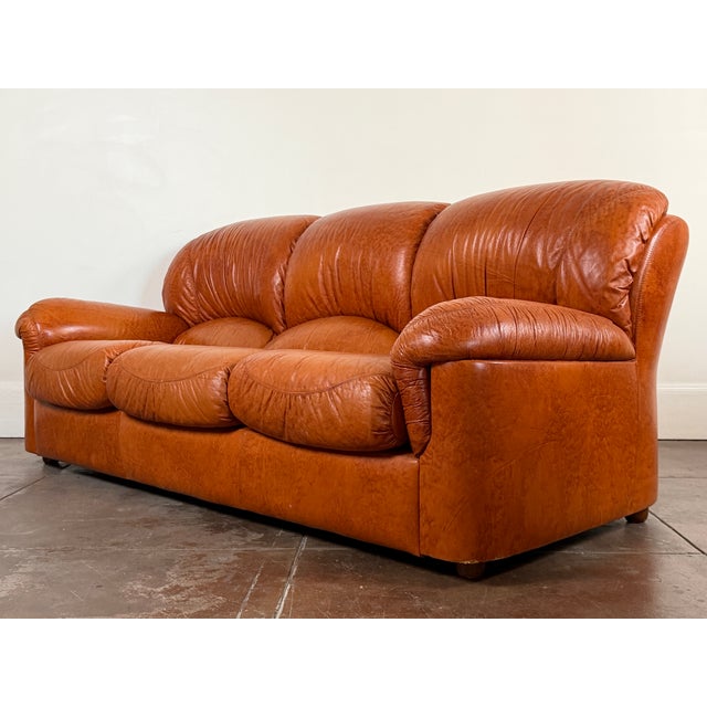 1970's Italian cognac leather sofa in good vintage condition. Minor scuffs consistent with age. Unsigned. Dimensions 81” x...