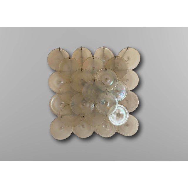 Wall lamp with iridescent Murano glass discs from Mazzega Murano, Italy, 1960. The wall lamp rests on a nickel-plated...