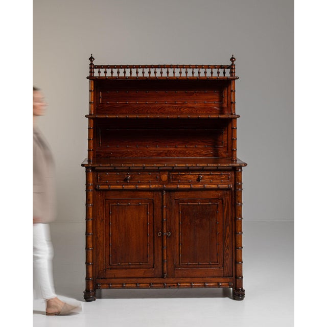 Here is a chest of drawers, its dark mahogany, turned finials, brass pulls the first thing to catch the eye. Dating to...