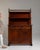 Here is a chest of drawers, its dark mahogany, turned finials, brass pulls the first thing to catch the eye. Dating to...