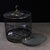 A beautifully crafted Chinese bird cage, likely made of black Zitan wood. The cage features a cylindrical form with...