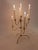 Elegant mid-century modern brass candelabra with adjustable arms that can be raised or lowered to create different...