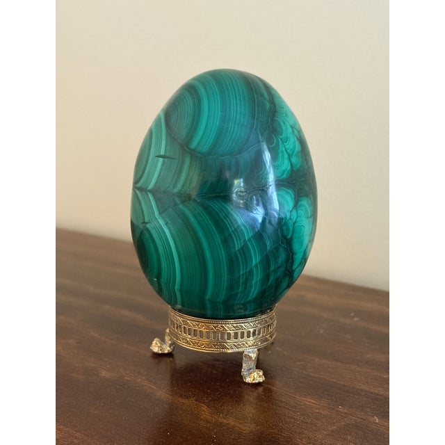 A stunning Russian style large malachite egg on Neoclassical style stand with paw feet Late 20th century Solid malachite...