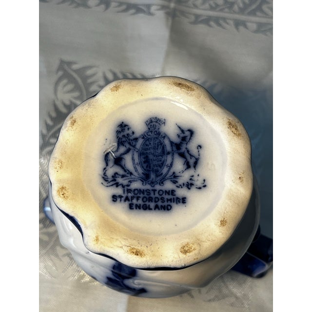 Antique Flow blue pitcher medium sized produced in 1870 by Stafgirdshire Ironstone in England . Perfect condition