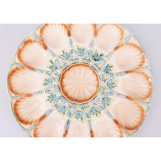 A gorgeous antique French Sarreguemines majolica peach oyster platter decorated with blue and green seaweed and blue rope...