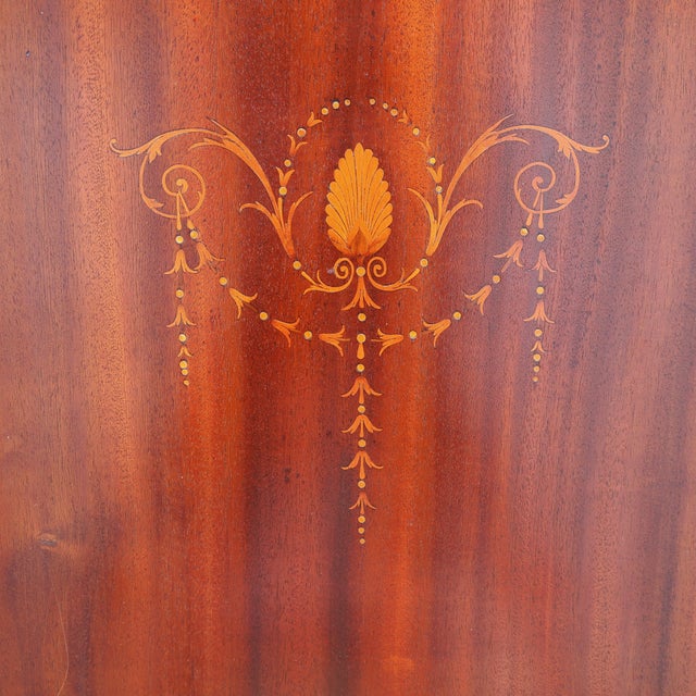 This elegant Edwardian Mahogany veneer cabinet was designed with narrow pull-out shelves to hold stacks of sheet music...