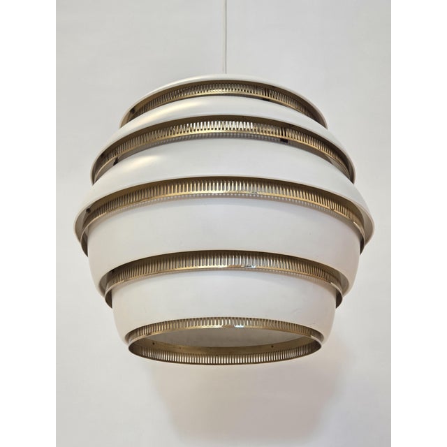 Artek A331 "Beehive" lamp, white/brass. Manufacturer Valaistustyö Ky. Designer Alvar Aalto. The lamp is in original good...