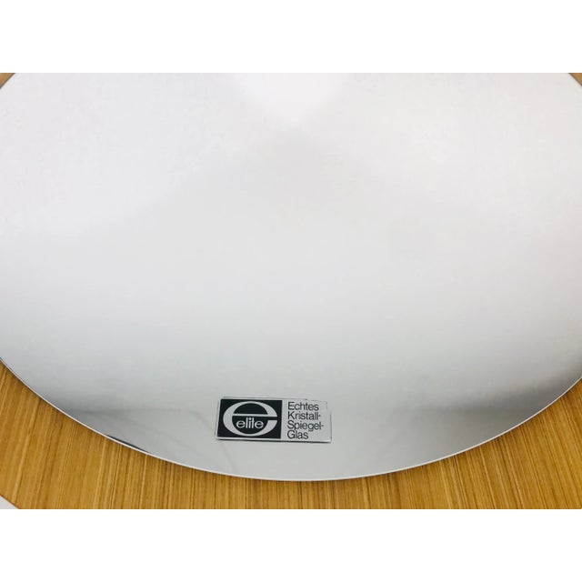 A round wall mirror from the 1960s made in Germany. The mirror has a circular design. The mirror is in a good vintage...