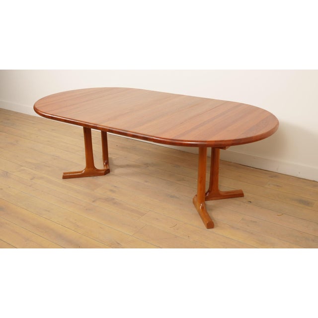 A stunning vintage round extendable dining table from the renowned danish manufacturer dyrlund, crafted from warm and...
