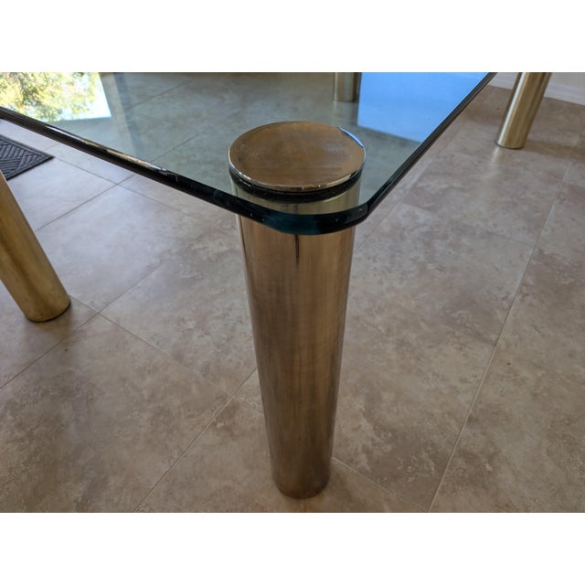 Glass and brass MCM Leon Rosen designed dining table for the Pace Collection. This classic Hollywood Regency meets Mid...
