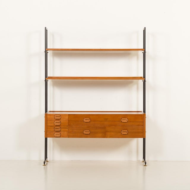 This freestanding mid-century shelving unit comes from italy, from the 1970s, and is made with richly grained teak....