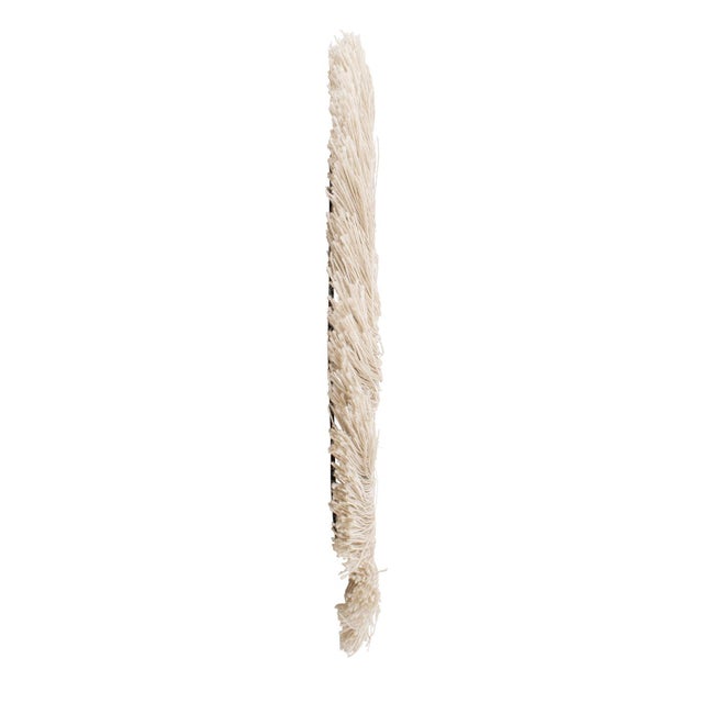 This mirror is framed with a delightful cotton fringe that creates a sense of movement and texture, making it a standout...
