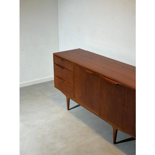 Elegant mid-century modern sideboard produced by McIntosh Furniture , crafted in beautifully grained teak wood and...