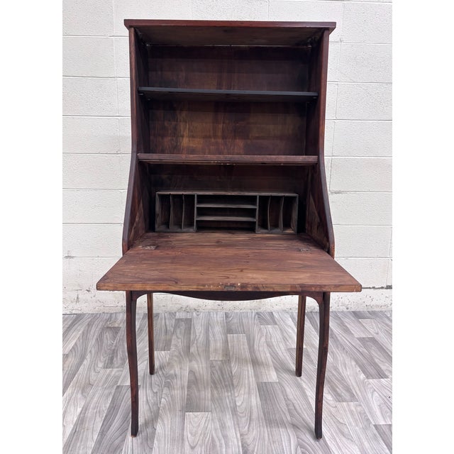 This is a charming antique 19th-century primitive country secretary desk and bookcase featuring rustic wood construction,...