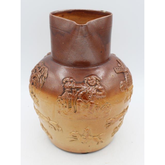 Late 19th century Royal Doulton, Lambeth, London stoneware jug. Molded, applied handle smartly decorated with faux screws...