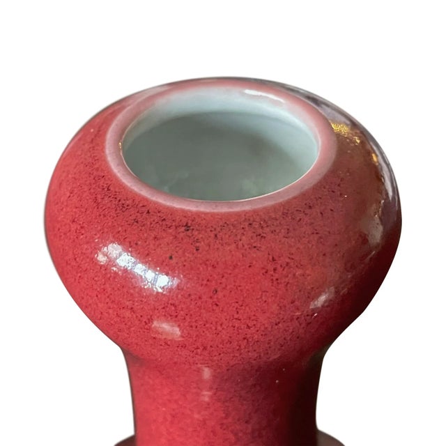 Chinese ox blood glazed garlic-head form vase. Rich red glaze over porcelain body. Apocryphal Qianlong mark to bottom.