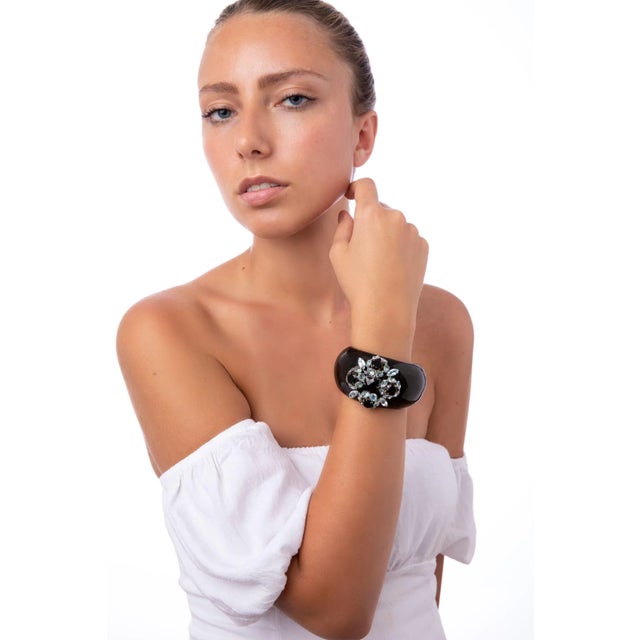 The Erin Cuff, crafted from semi-precious stones, is an exquisite horn cuff adorned with multiple colorful stones,...