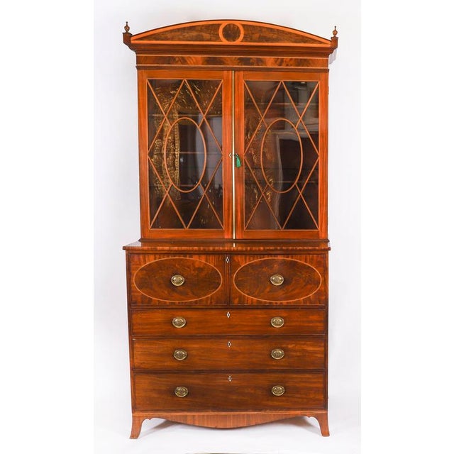 This is a beautiful antique George III inlaid flame mahogany and satin wood crossbanded secretaire bookcase, circa 1815 in...