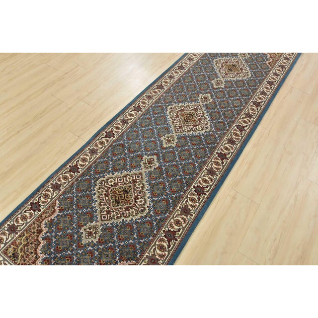 A traditional Tabriz Mahi runner hand-knotted with an all-wool pile on a cotton foundation. This finely woven oriental rug...