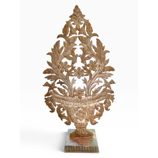 A striking pair of urn form repoussé garnitures with floral and botanical designs complete parrots and hummingbirds. The...